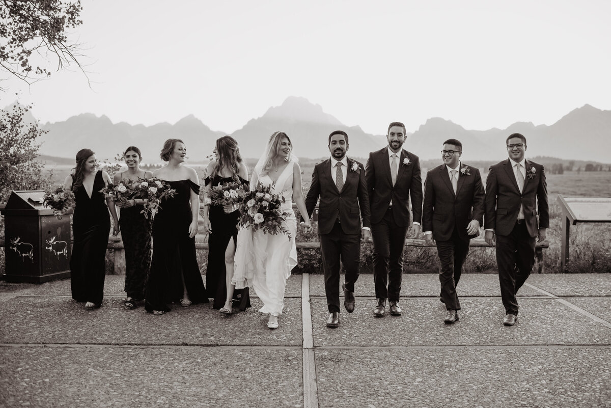 Photographers Jackson Hole capture bride and groom walking with wedding party