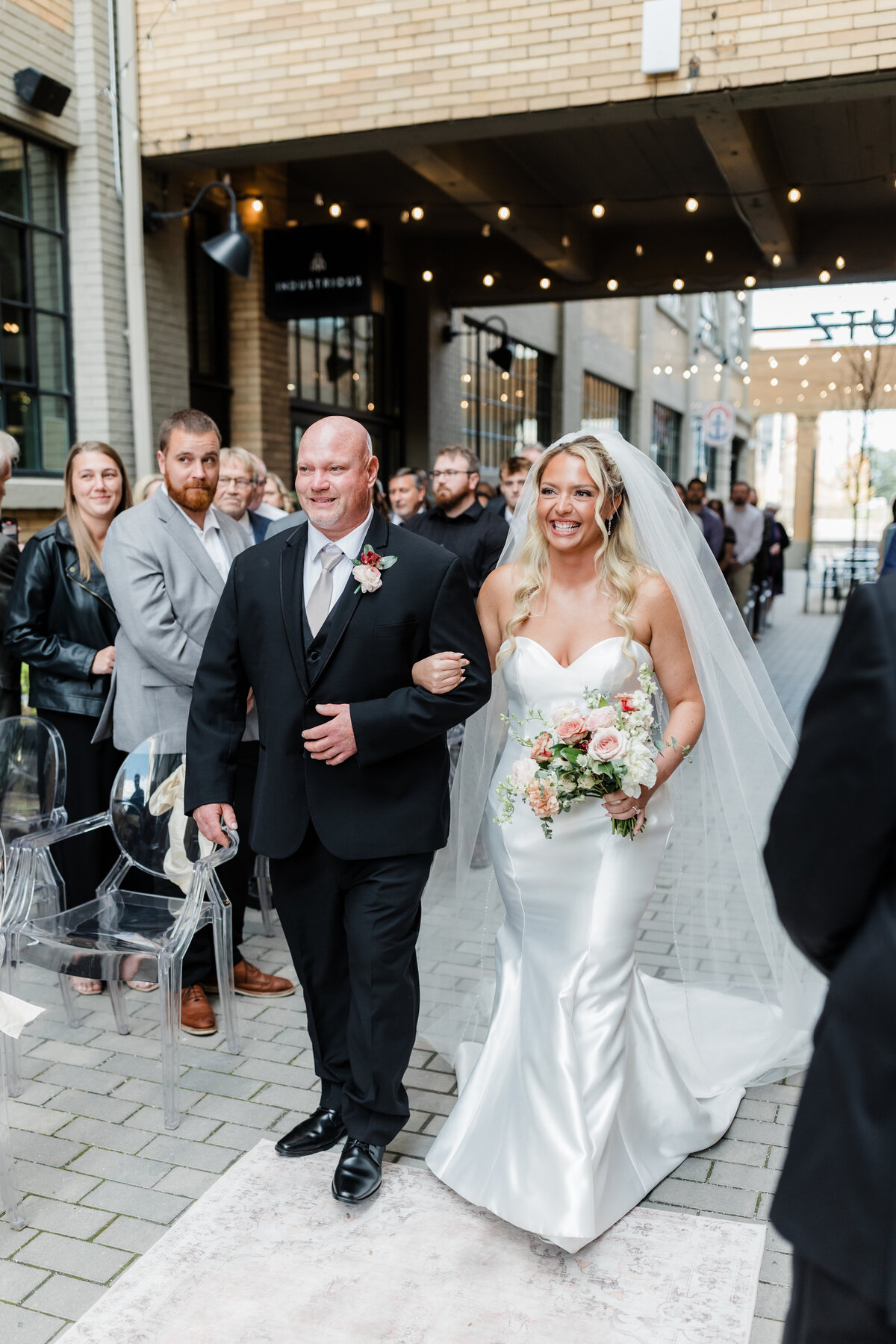 Bride walking down the aisle with her father during a South Bend wedding ceremony.