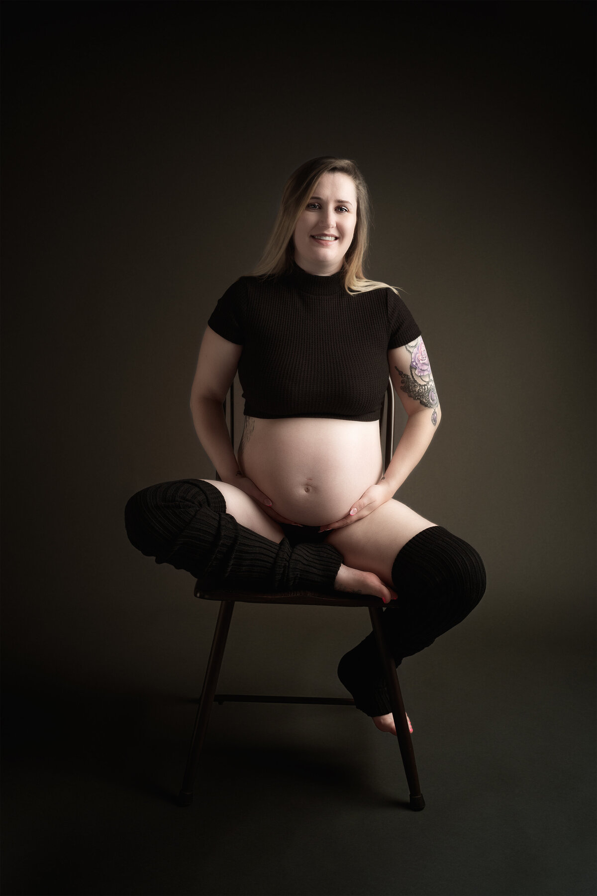 Classic studio in Paris, Ontario maternity portrait of smiling mom on a dark backdrop | Meraki Photographic Creations