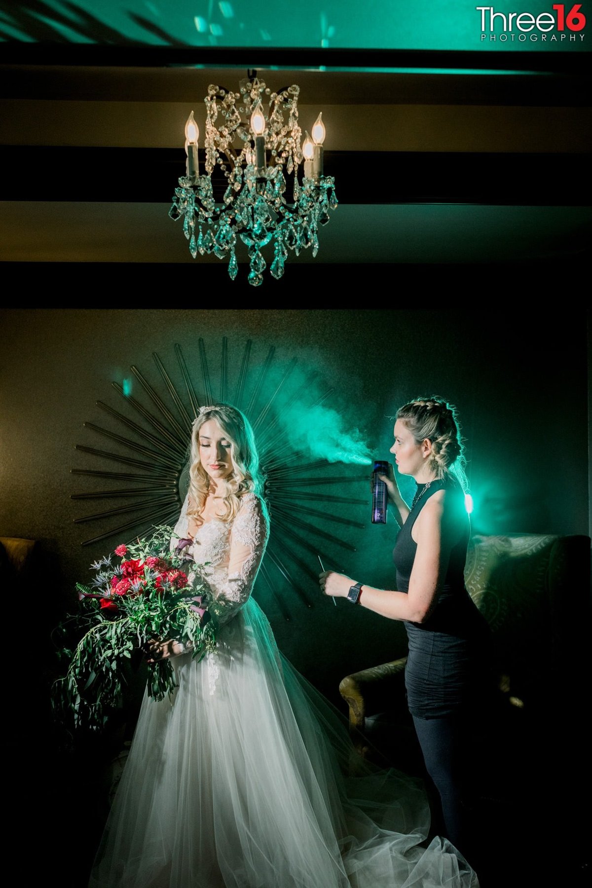 Final hairspray touches on the Bride before the wedding ceremony