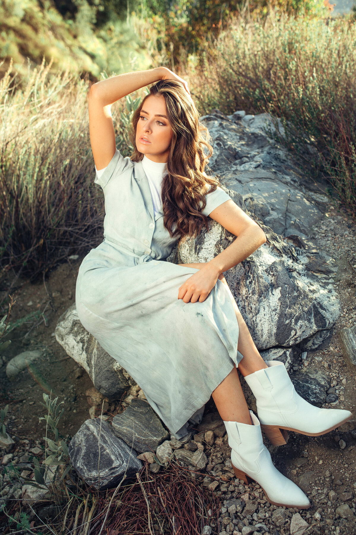 Portrait Photo Of Young Woman In White Dress Sitting On a Rock Los Angeles
