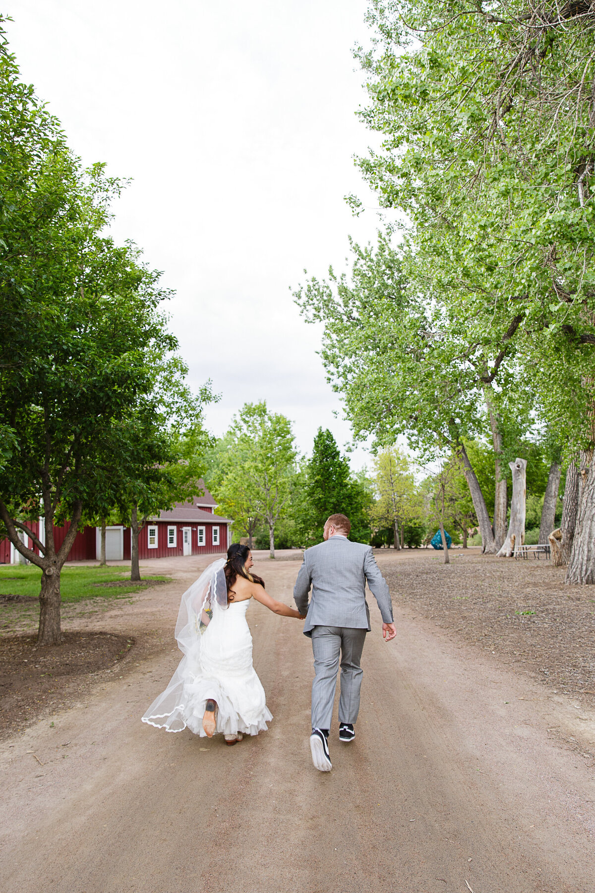 fun-candid-running-bride-and-groom-hudson-gardens-colorado