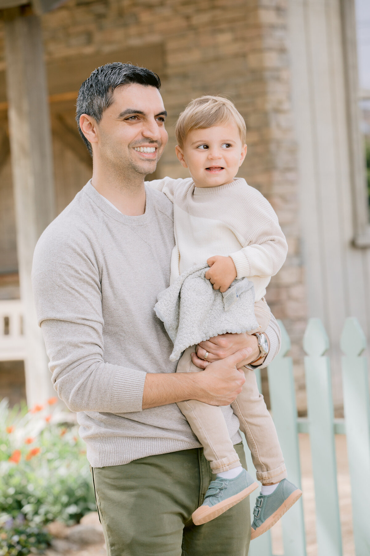 A dad smiling as he holds his child