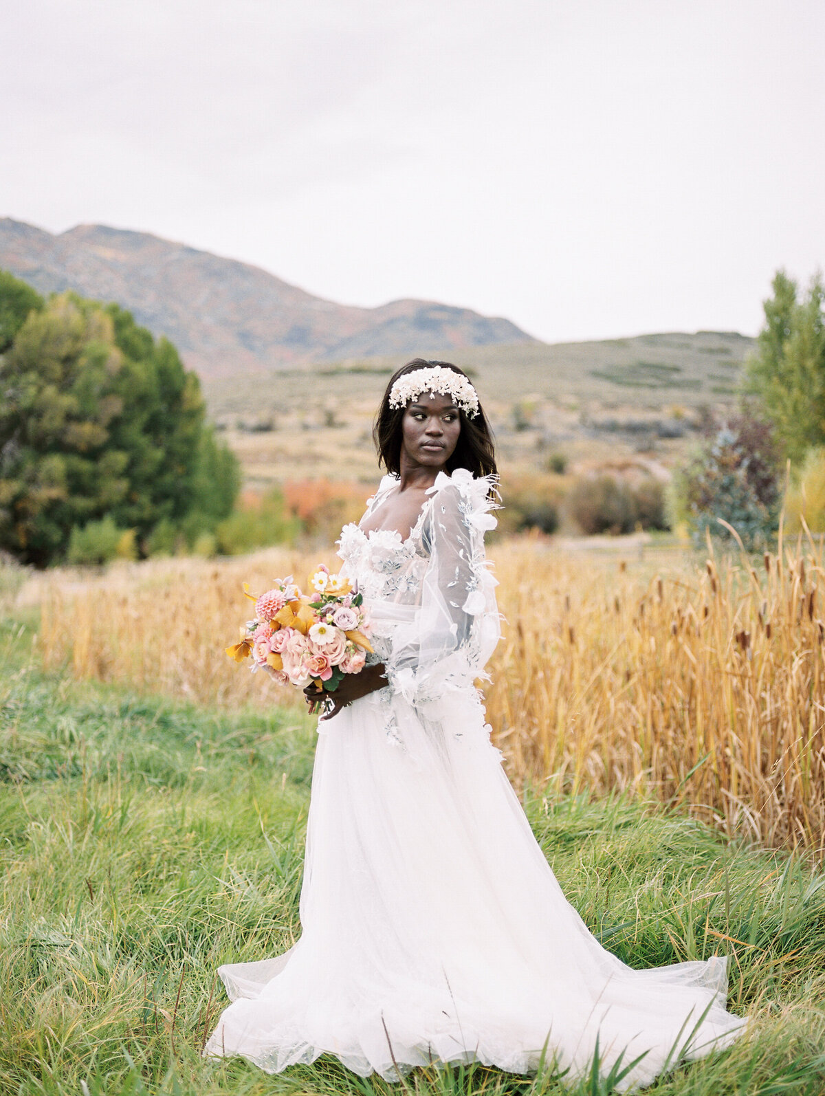 A gorgeous black bride looks over her shoulder off to the distance