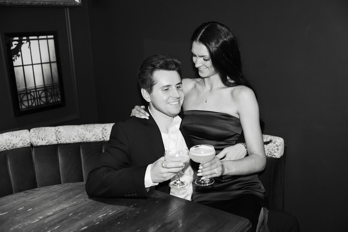 A couple enjoys cocktails at the chic bar inside Venteux in downtown Chicago, captured in an elegant and stylish engagement session.