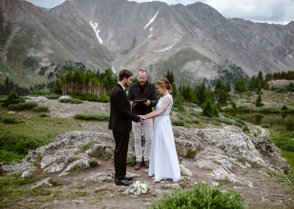 Bride and Groom have their ceremony at Loveland Pass in Colorado with their officiant 