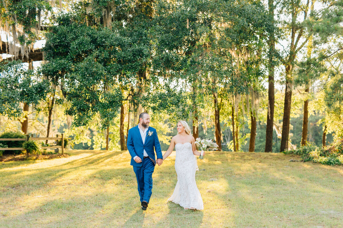 bride and groom walking in summer field winx photo knoxville tennessee wedding photographer