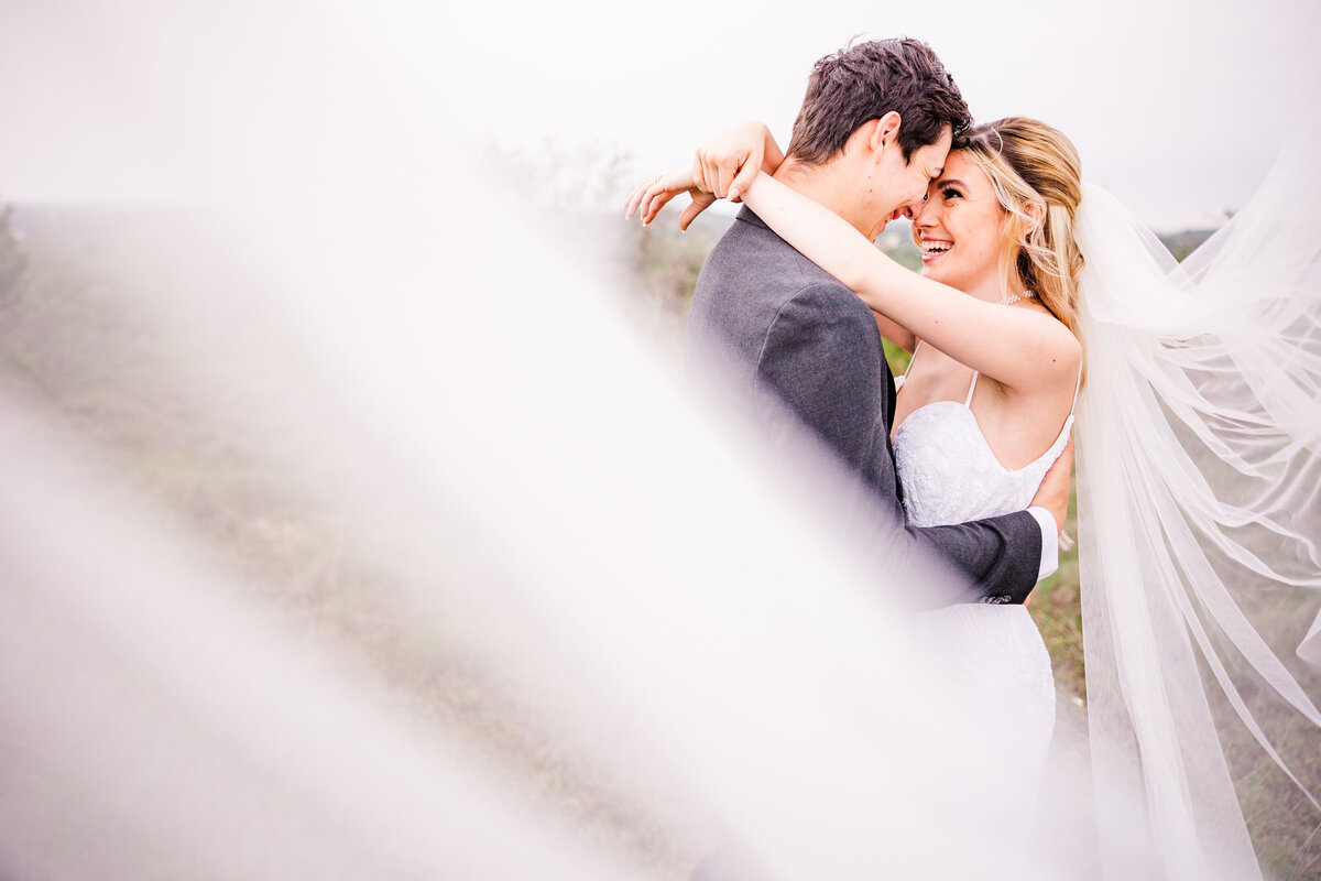 Bride & Groom embrace at the Terrace club wedding venue in Dripping Springs, Texas.