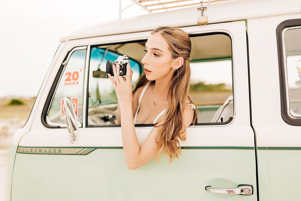 Senior portrait with a timeless outfit and vintage camera