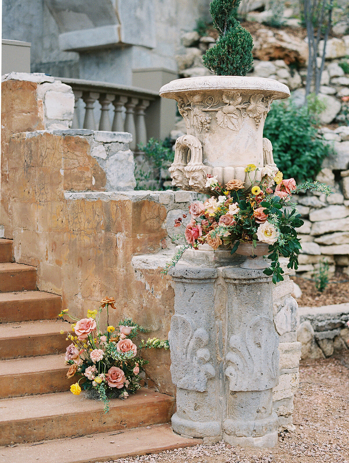 Flowers adorn the stone steps that lead down to the reception area at Villa Antonia
