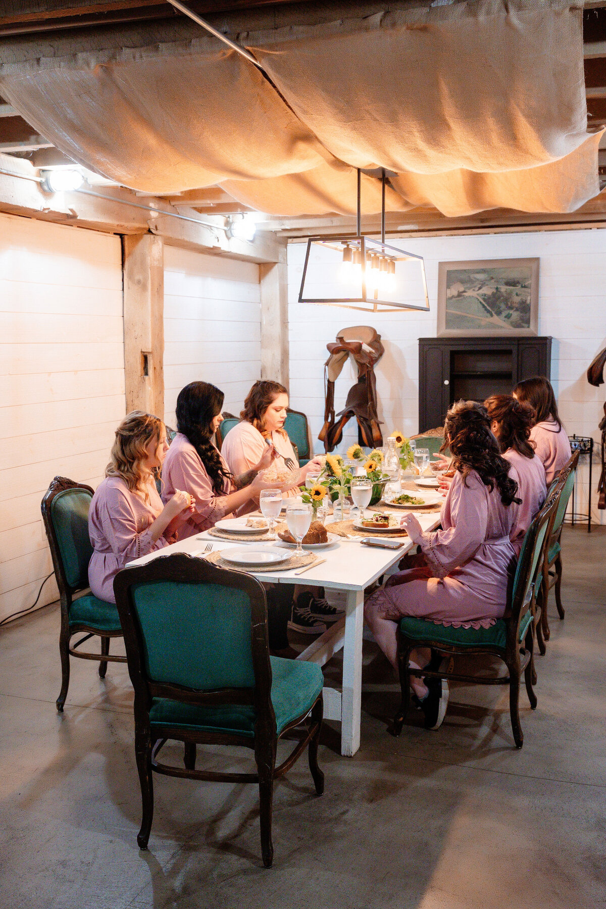 bridesmaids eating lunch in the barn before the wedding day