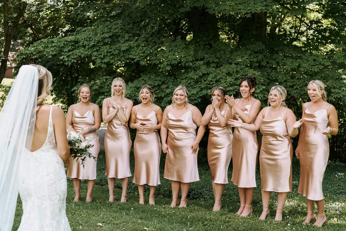 first look with bridesmaids outside wedding venue at windridge estate