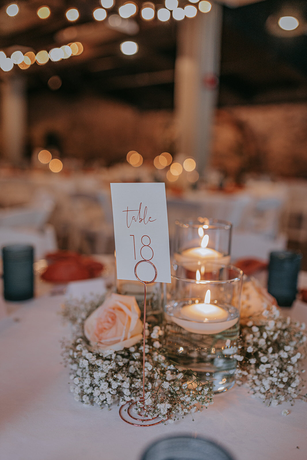 Dining table with floral centerpiece and seating number 18