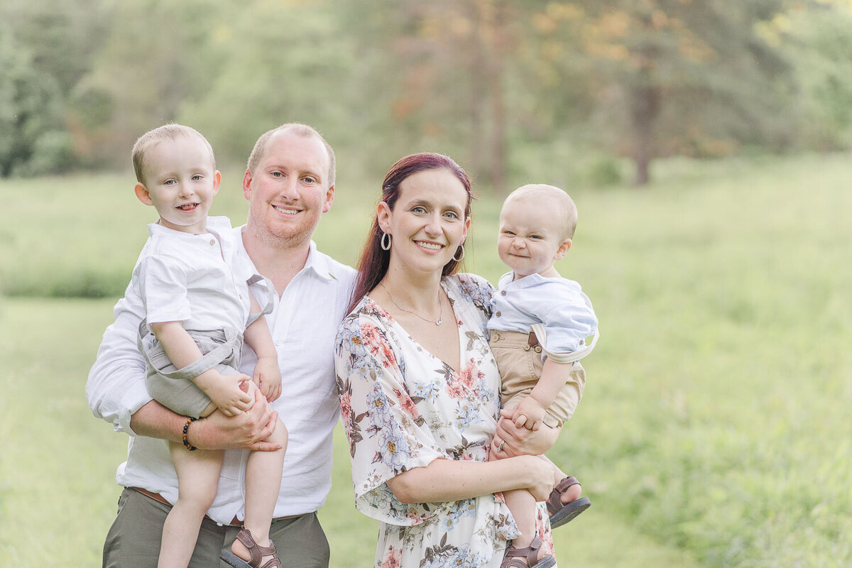 family of 4 posing for photos during spring mini session taken by Centreville, VA photographer