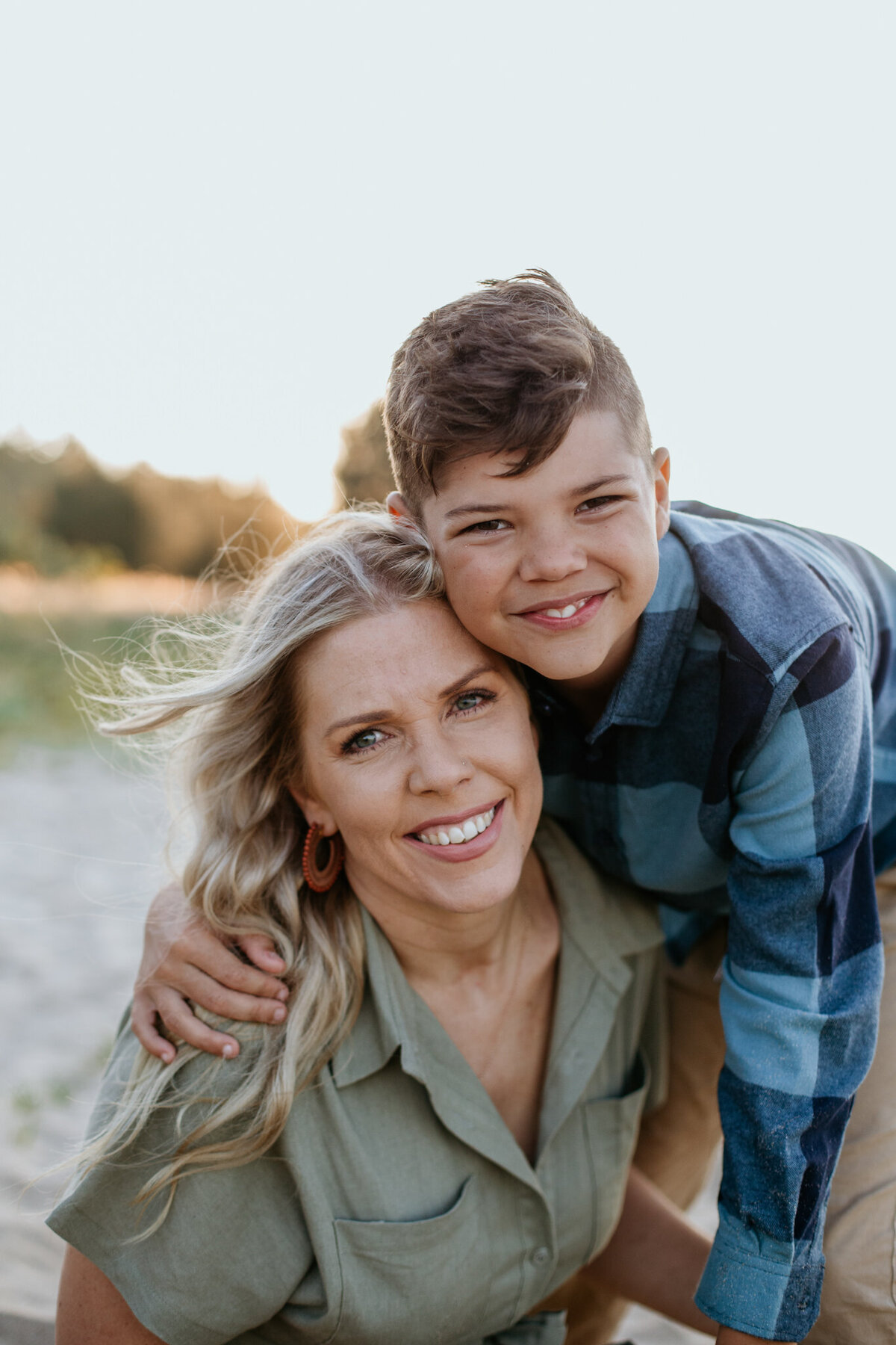 Mom and son share a hug on the beach