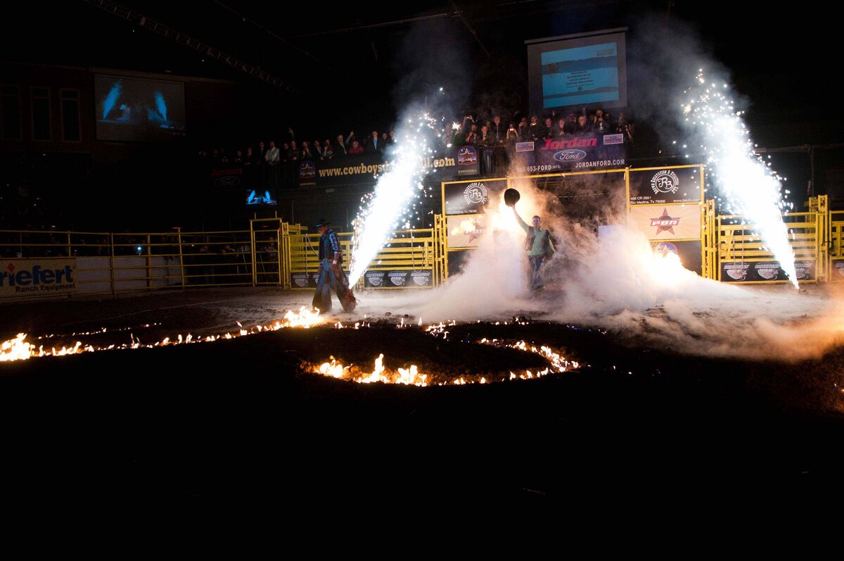 Sparks and fire show welcome spectators before professional rodeo begins.