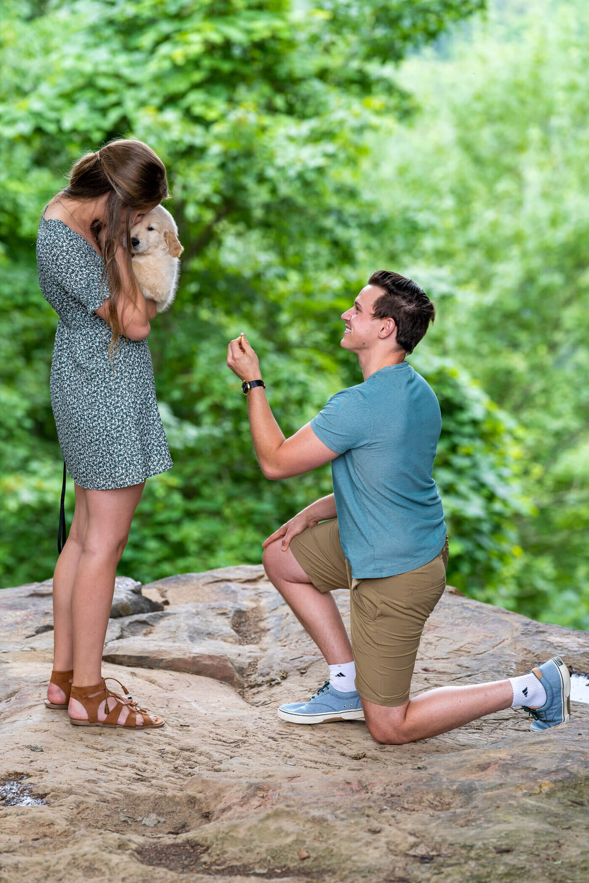 Candid portrait of Michael Proposing to Deidra with their puppy, Theo