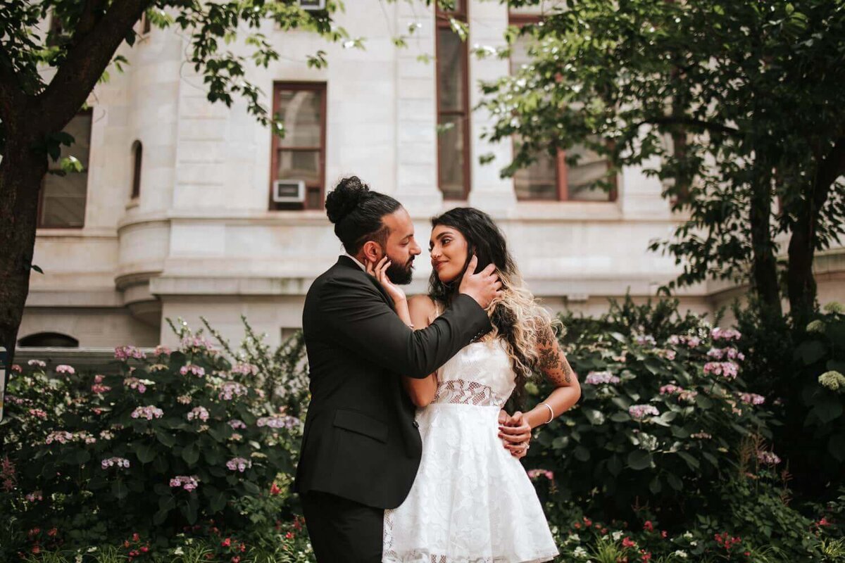 South Asian couple staring at each other embracing a moment of solitude in Philadelphia.