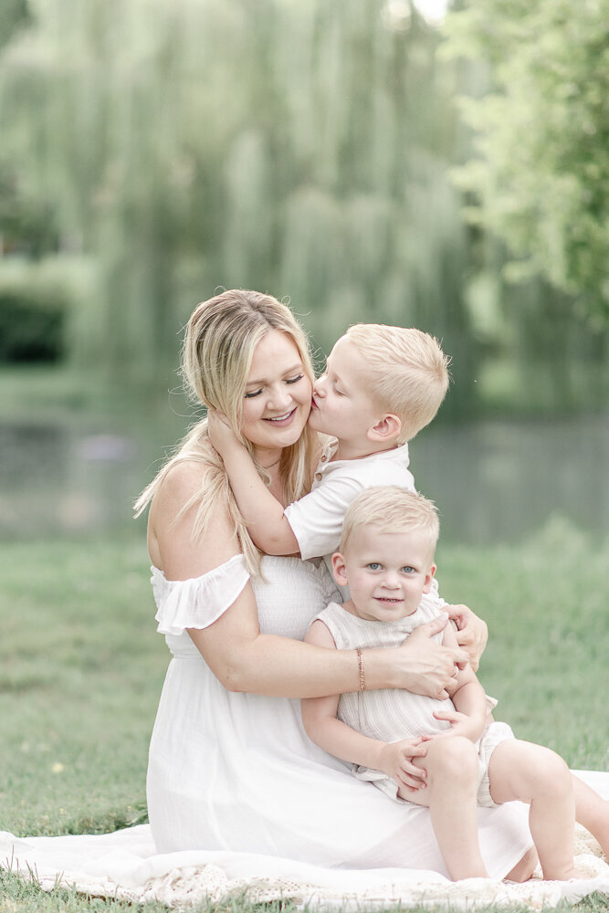 A mother holds her two toddler sons By Nashville maternity photographer Kristie Lloyd