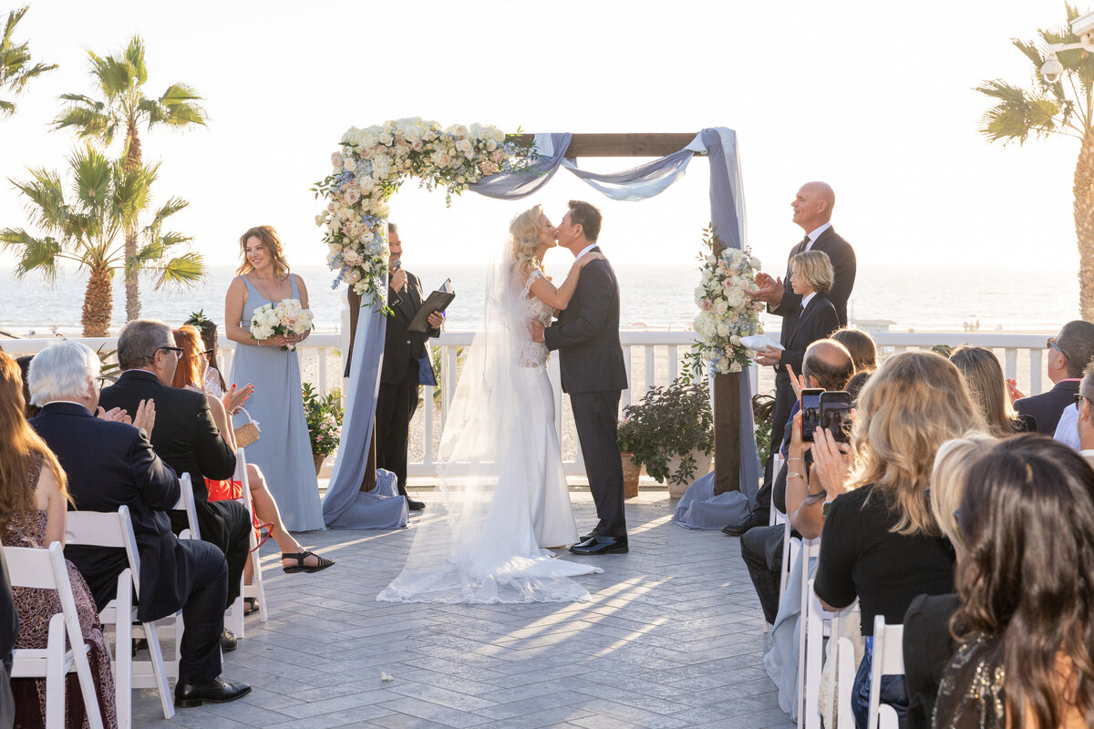 A bride and groom during their first kiss