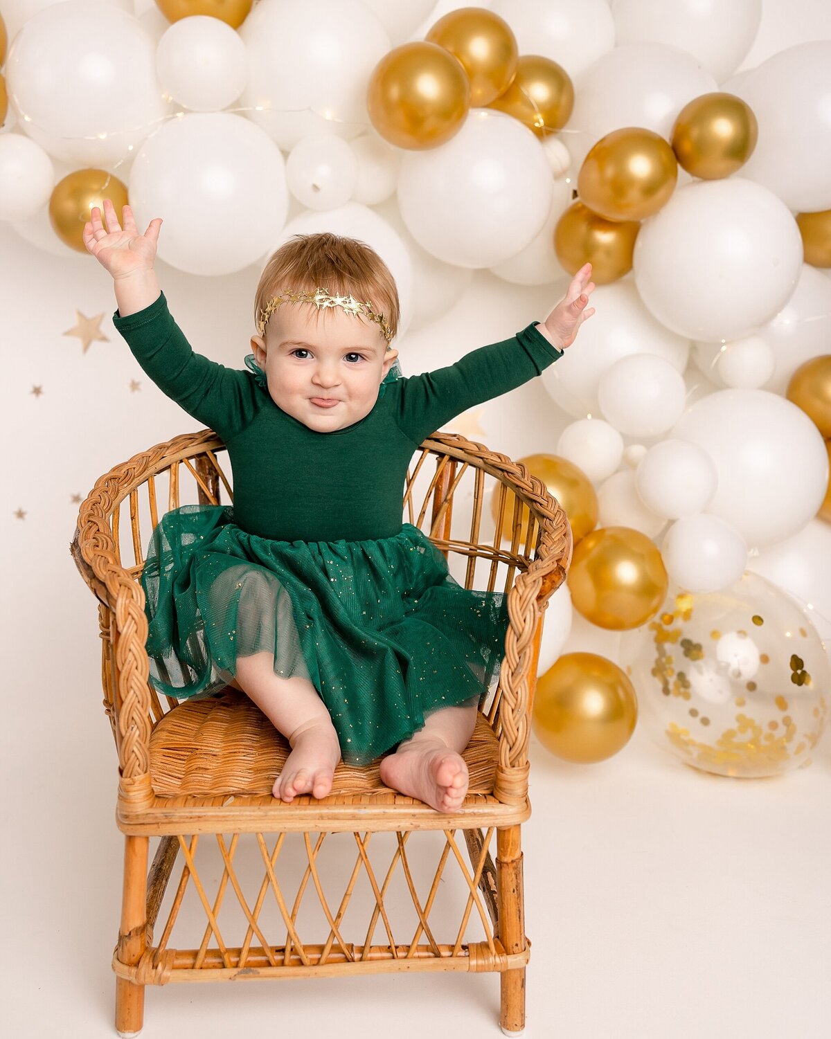 first birthday pictures of girl sitting in chair in porland studio