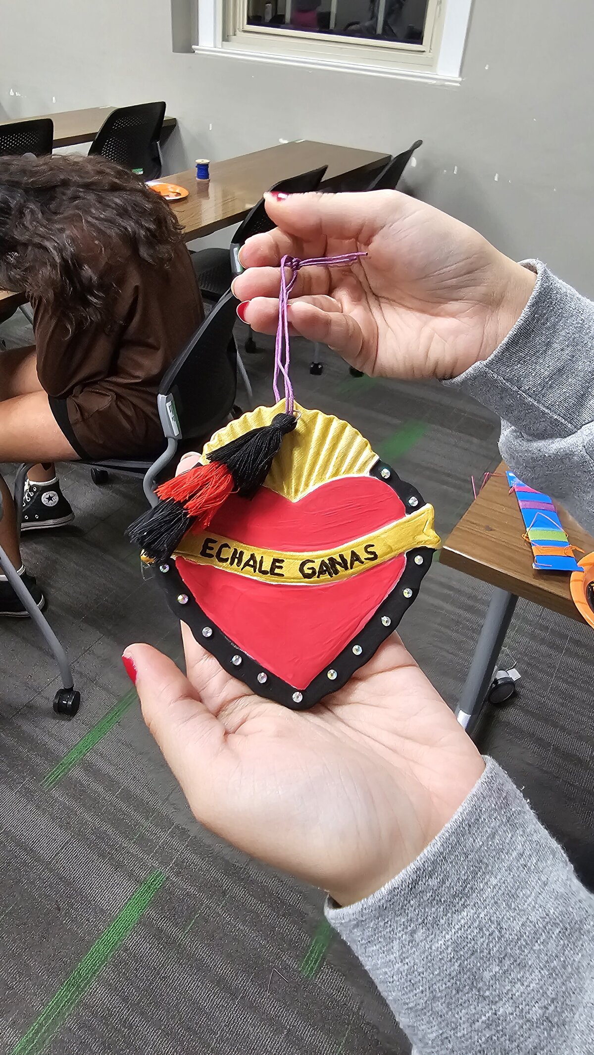 The artistic triumph as a workshop participant proudly presents their final masterpiece—a colorful heart adorned with an inspirational phrase. Tthe materials that brought this creation to life at Soleil Vida Studio.