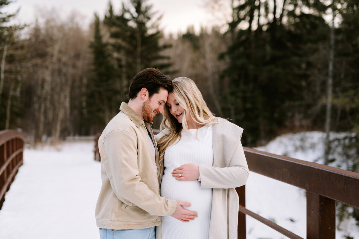 A winter maternity photo session at Fish Creek Provincial Park