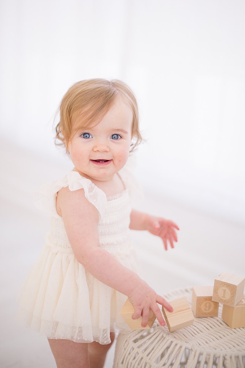 Little girl playing with wooden blocks