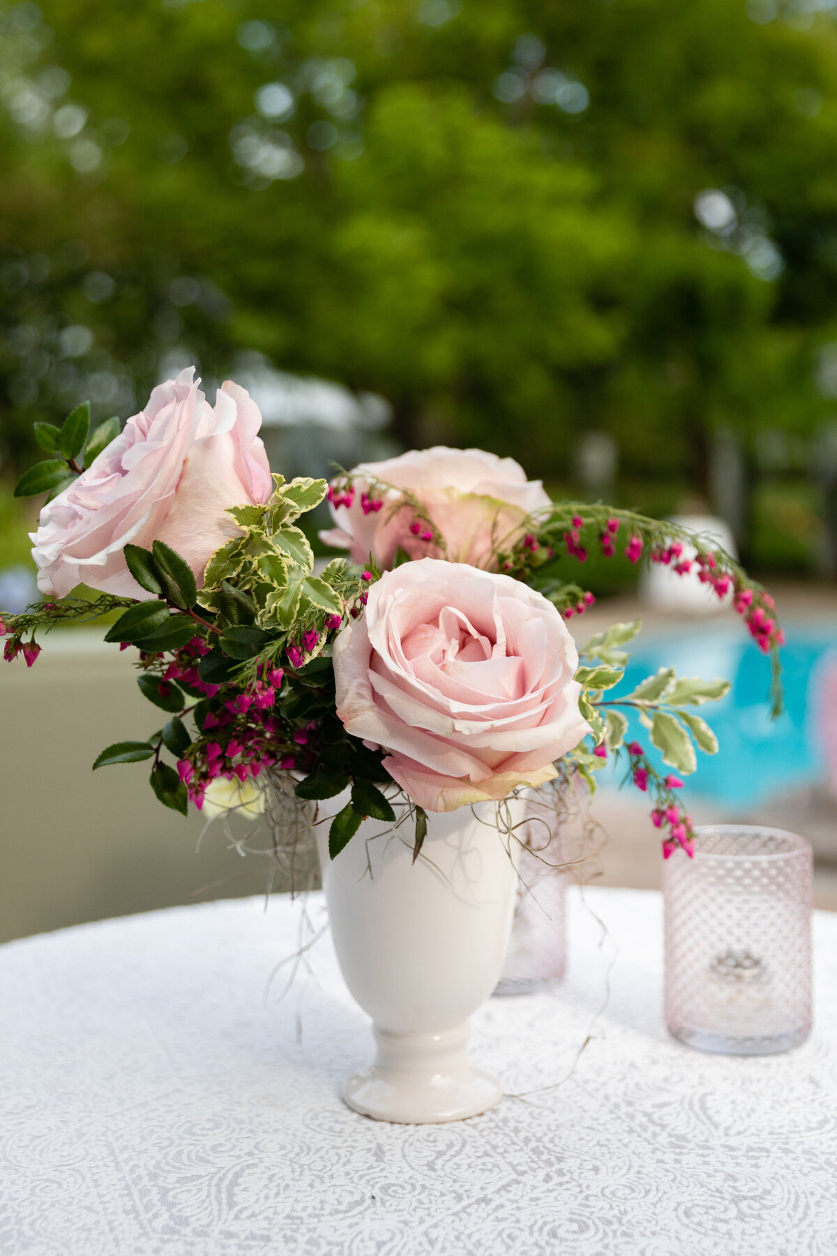 Bridgerton inspired engagement party at a private home in Nashville, TN with color blocked flower arrangements in shades of pink, blue, and lavender with matching votives candles. Natural greenery, garden roses, ranunculus, and wildflowers.