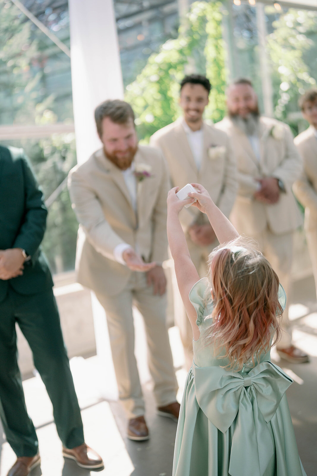 Adorable moment of the ring bearer handing the ring to the best man during the Ivy House ceremony.