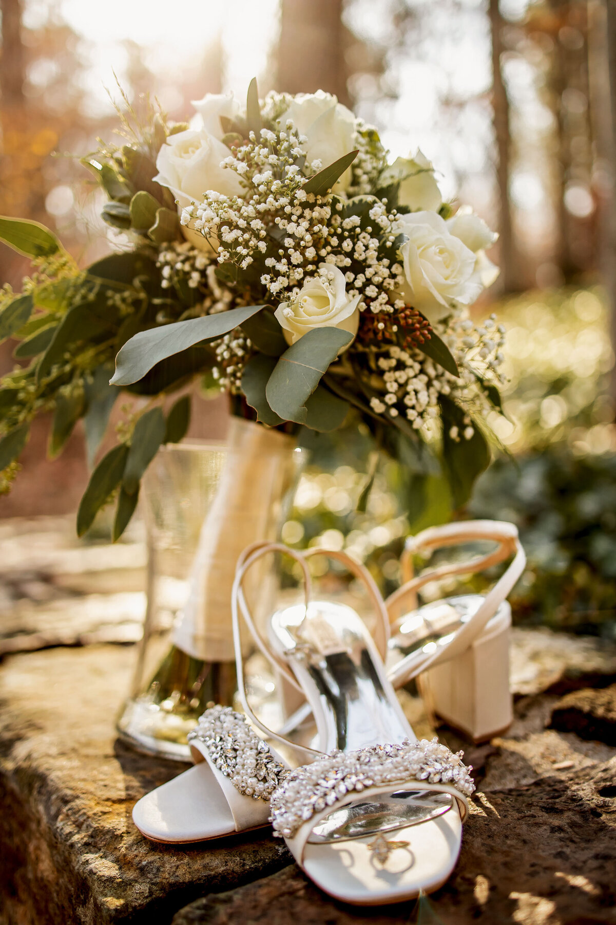 wedding bouquet with shoes and an engagement ring