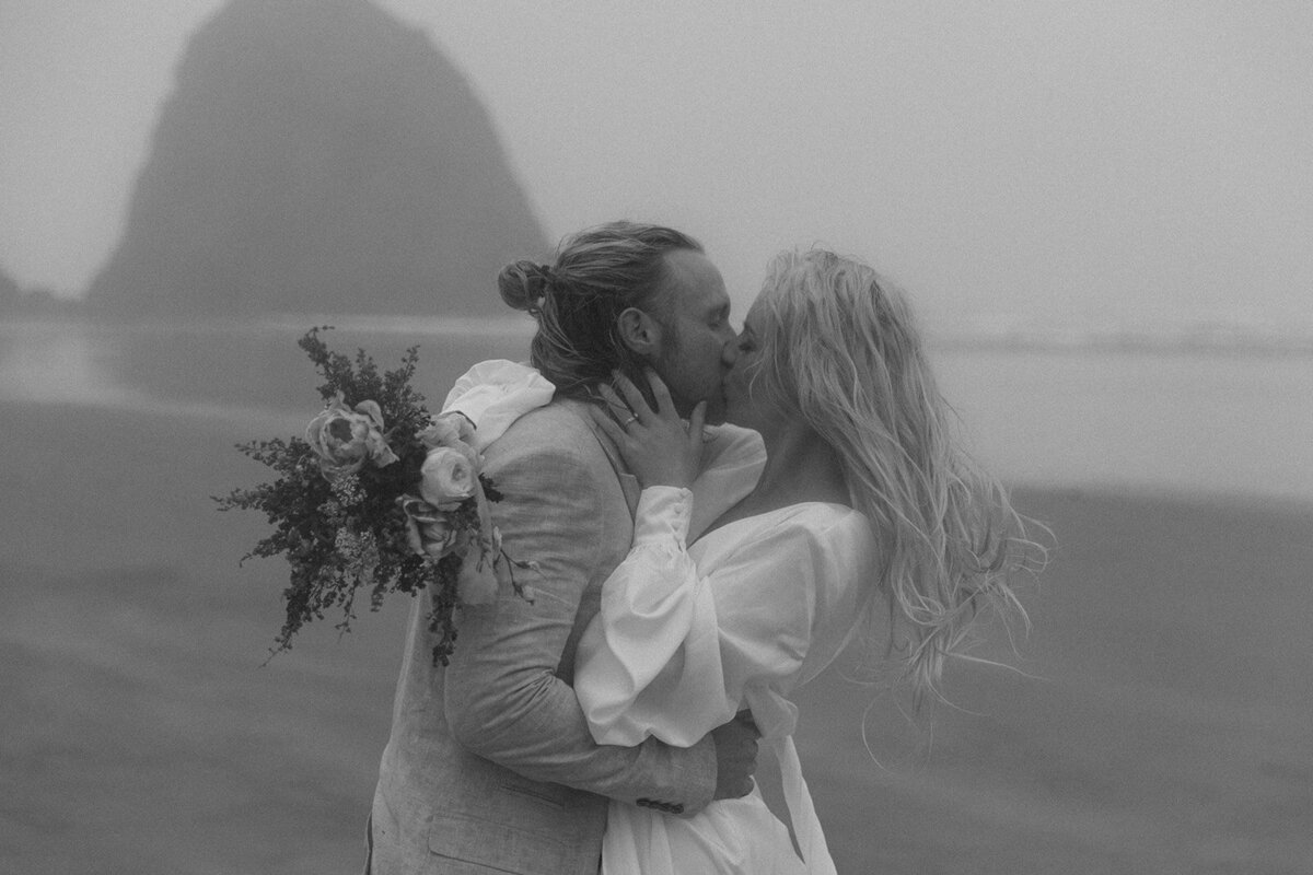Black and white photo of couple kissing on the beach during an intimate destination elopement.