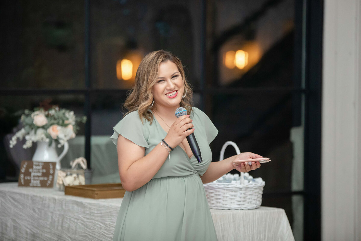 maid of honor gives speech in sage green dress at Austin area wedding