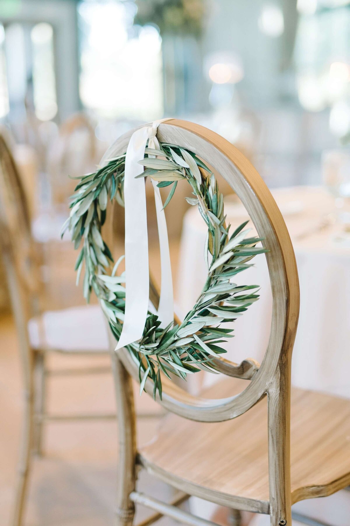 green wreath on wedding reception chair
