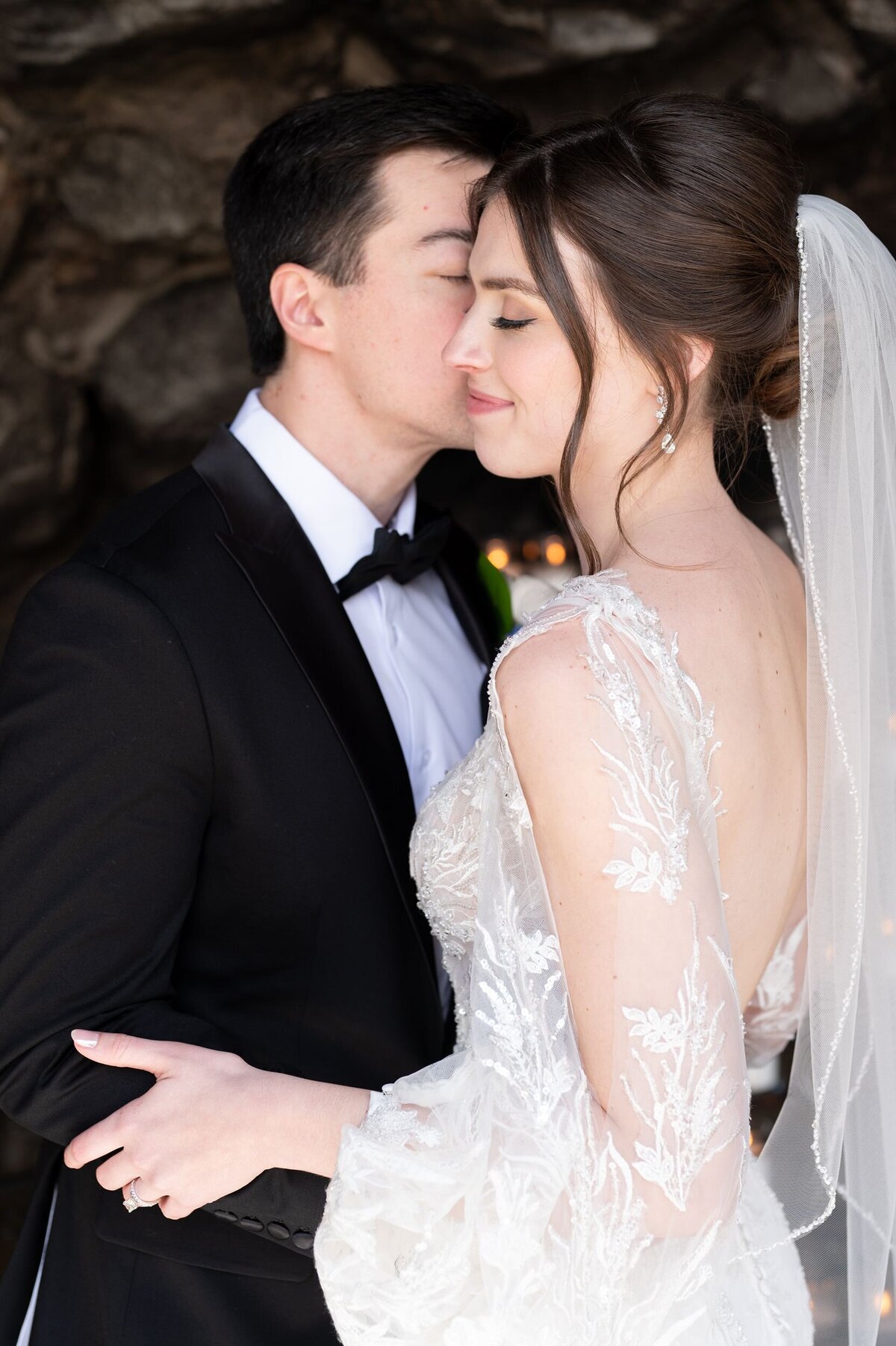 Groom kissing bride on cheek