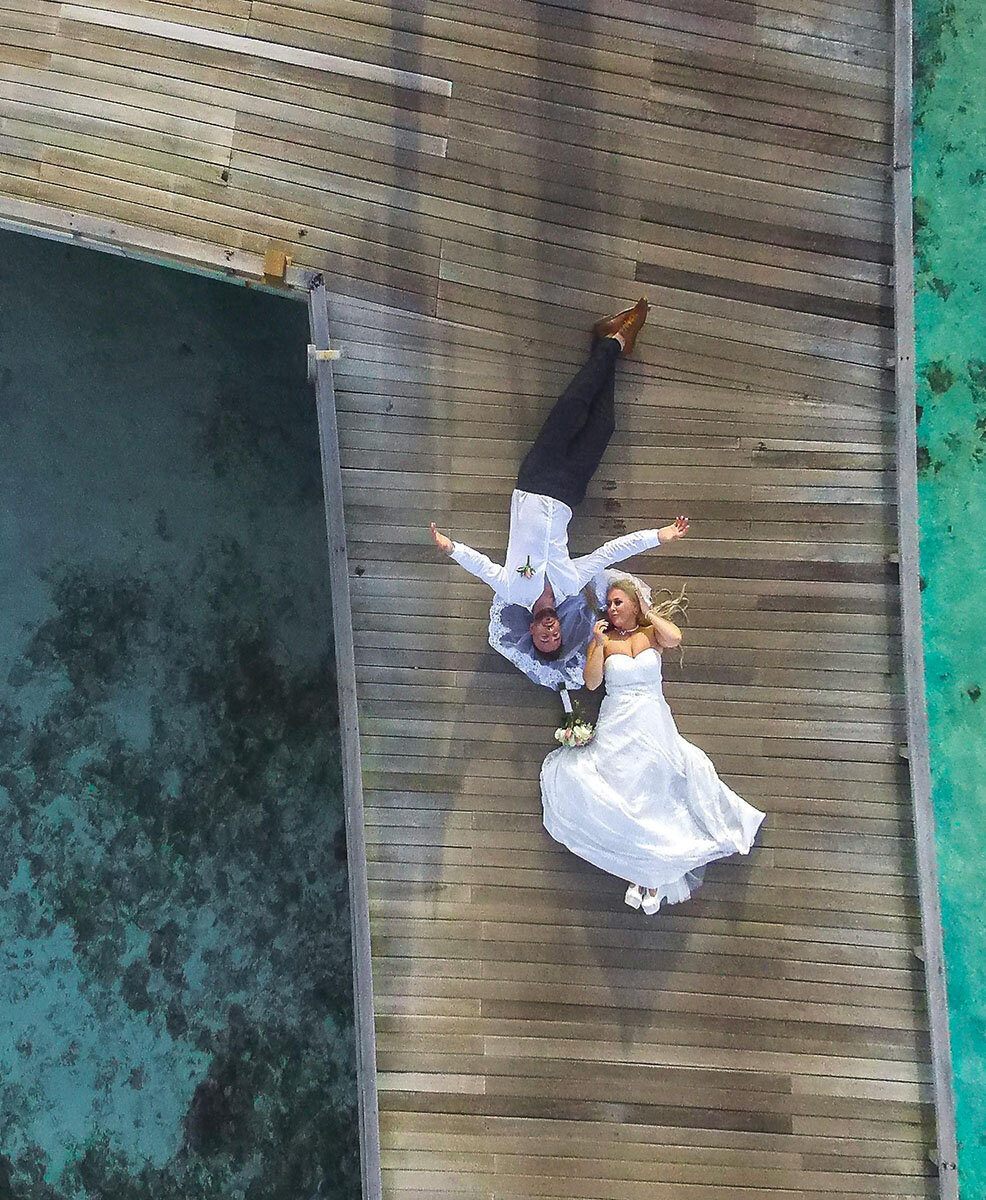 Laying on deck bride and groom