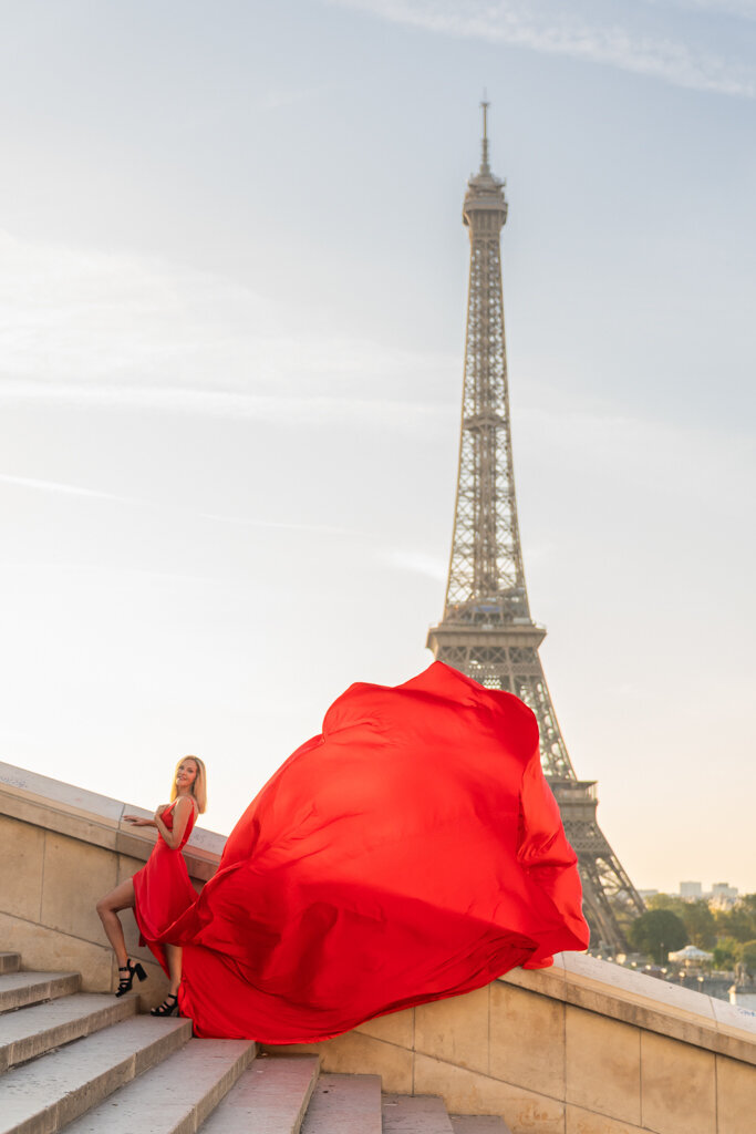 Trocadero stairs portrait featuring woman in flowing red dress during Paris photoshoot