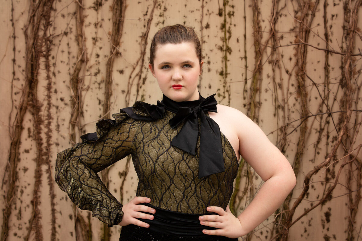 senior-with-hands-on-hips-in-black-dance-costume-and-red-lips-in-mansfield-tx