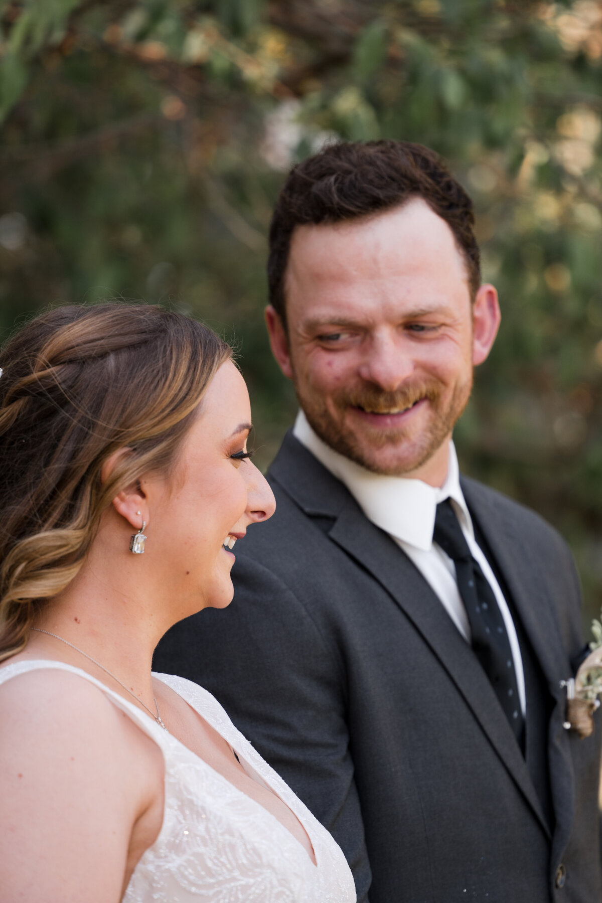close up of a groom looking at his wife with adoration 