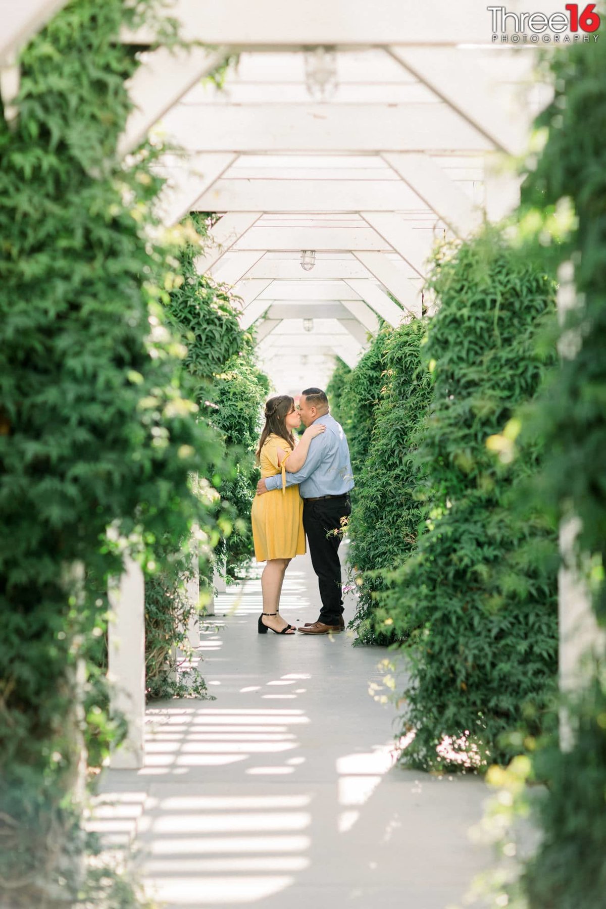 Engaged couple share a kiss at the Heritage Museum of Orange County