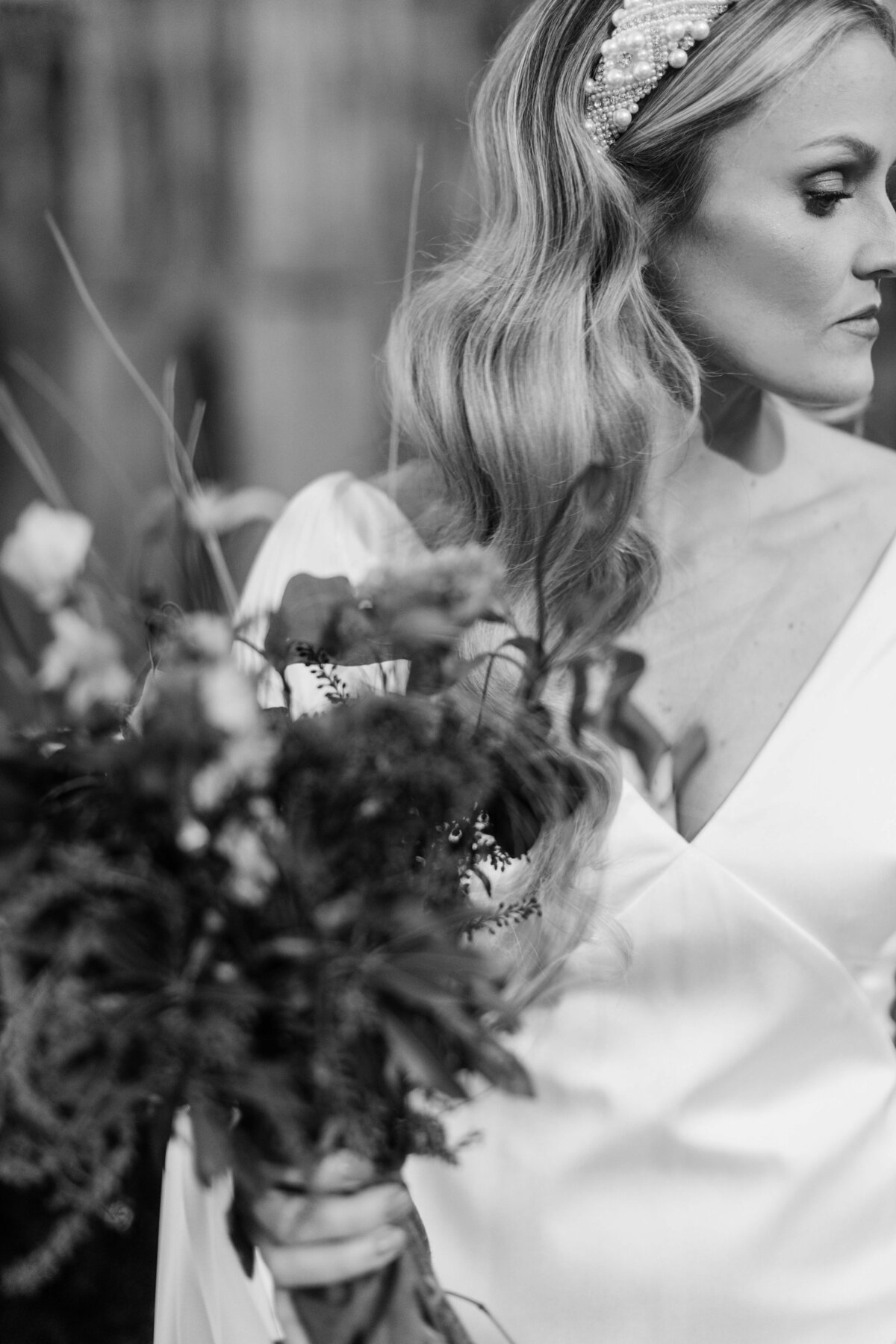 Stunning image of a bride holding a bouquet in black and white