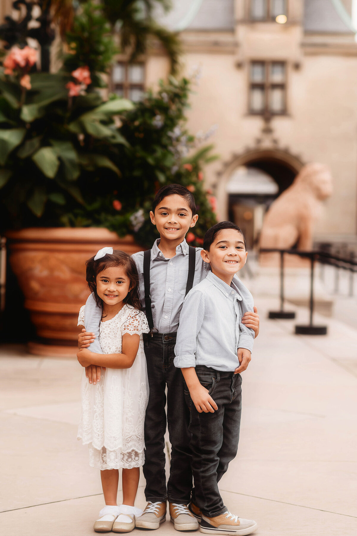Siblings embrace each other during Family Photoshoot at Biltmore Estate in Asheville, NC.