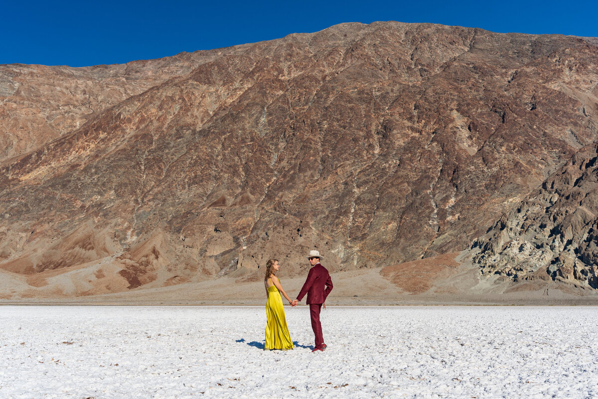 Newlywed standing in the middle of salt flats