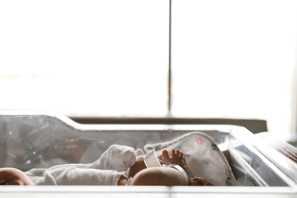 Newborn baby's toes in a bassinet by Elle Baker Photography