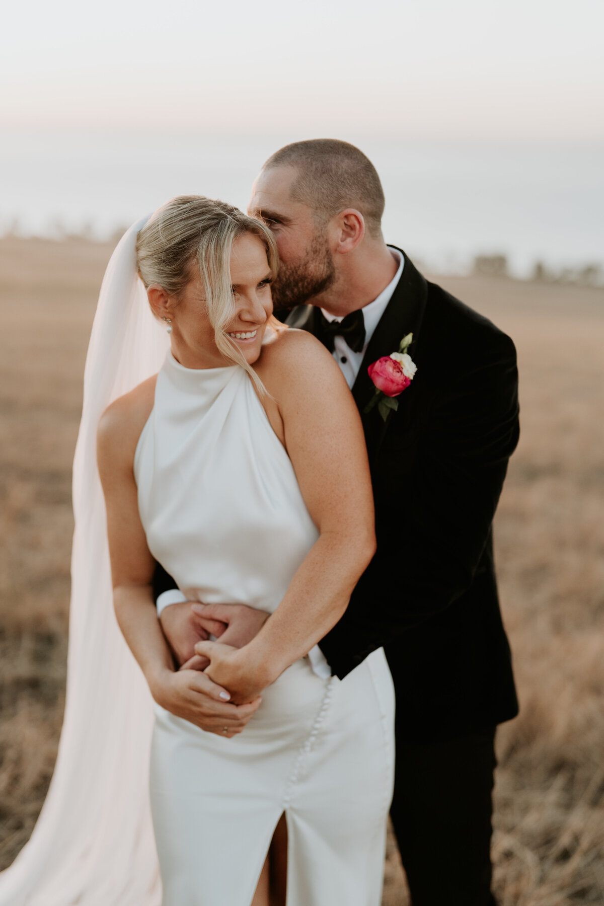 Bride and groom kissing during sunset at Jack Rabbit Vineyard