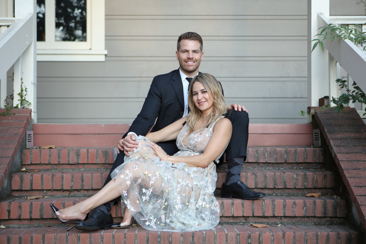 Young couple engagement portraits, rustic theme on stairs