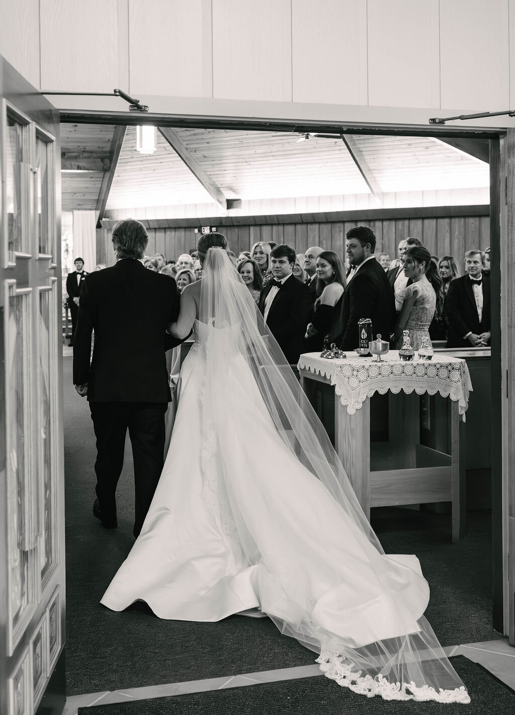 Bride walking down the aisle with her father during a classic church ceremony before the fall wedding reception at The Bascom Center in Highlands NC.