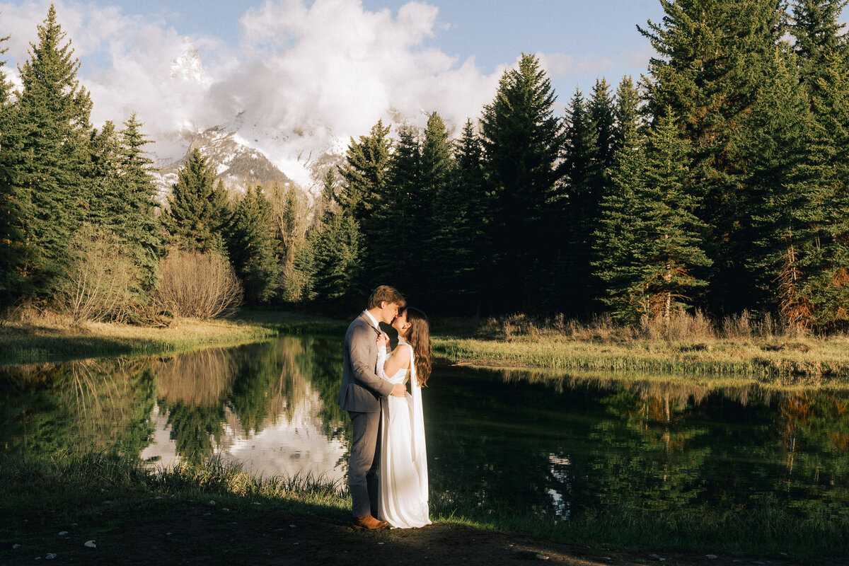 couple eloping in Schwabacher Landing during sunrise in late May.