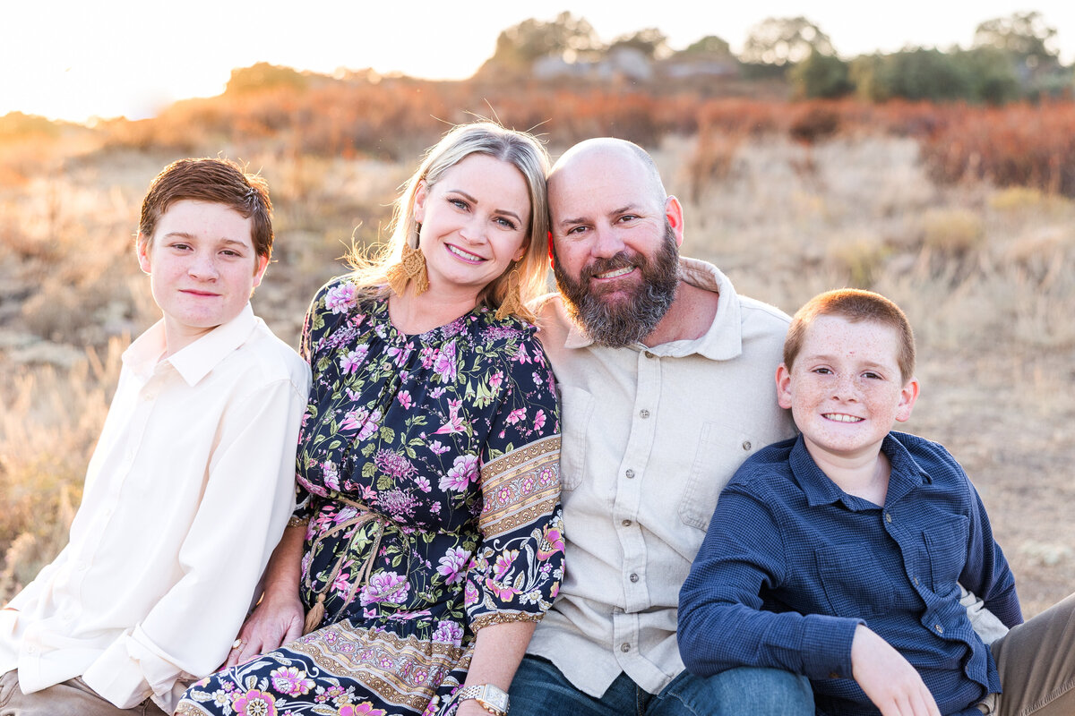family sitting on rock at wrights field san diego