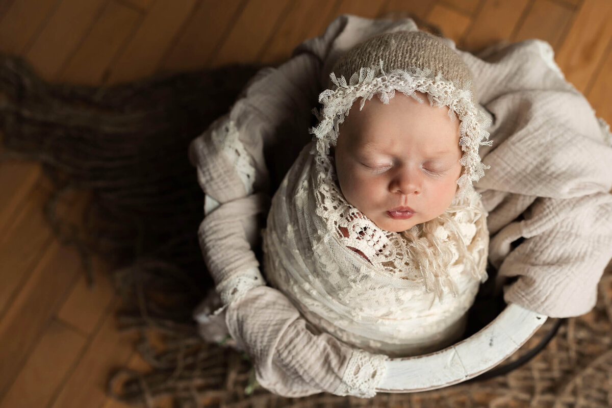 NJ Newborn photographer captures sweet baby girl in bonnet and lace wrap